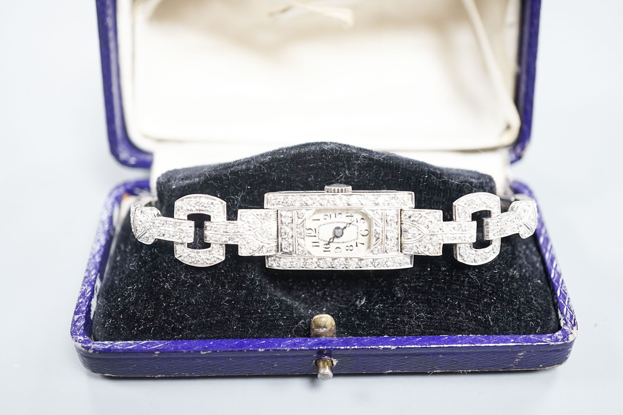 A lady's white metal (stamped platinum) and diamond set cocktail watch, the bracelet with diamond set shoulders, approx. 16cm, gross weight 23.8 grams.